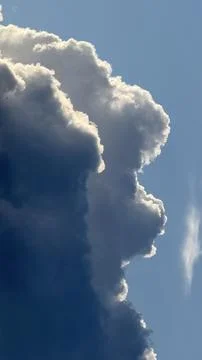 Towering cumulus cloud formation showcasing a striking contrast between deep Stock Photos