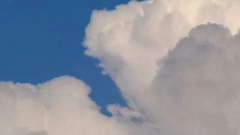 Towering Cumulus Cloud Mass Rising Against Deep Blue Tropical Sky Video stock 336650504