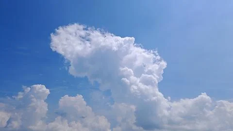 Towering Cumulus Clouds Against Bright Blue Sky Stock Photos