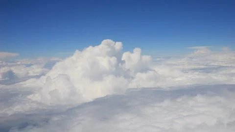 Towering cumulus clouds with a blue sky background, creating a peaceful aer.. Stock Footage 293124038