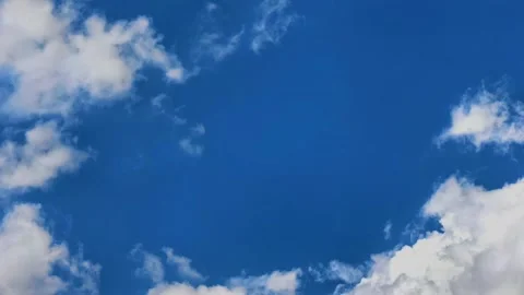 Towering cumulus clouds build against a blue sky in time lapse, dramatic cloud Stock Footage 340190650
