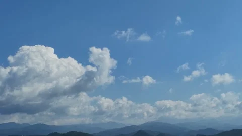 Towering Cumulus Clouds Over Mountain Silhouette Stock Footage 346734621