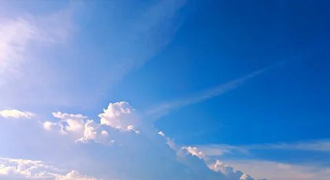 Towering Cumulus Clouds under Bright Blue Sky Background Stock Photos