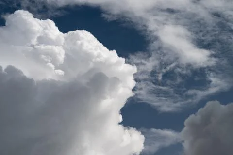 Towering cumulus clouds under stormy sky, massive white formations with deep  写真素材
