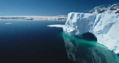 Towering glacier arch with icicles in Antarctica Stock Footage 264326171