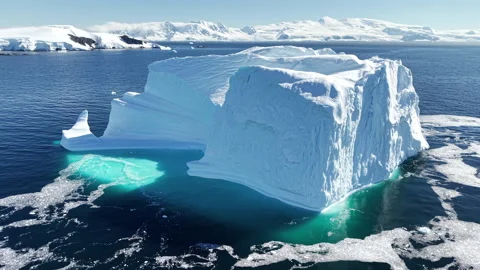 Towering Iceberg Surrounded by Sea Ice in Antarctica Stockbeeldmateriaal 343374731
