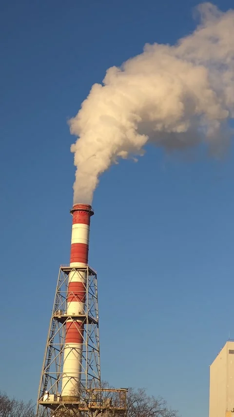 A towering industrial chimney ejecting thick smoke at high speed. Close-up .. Stock-Footage 296756591