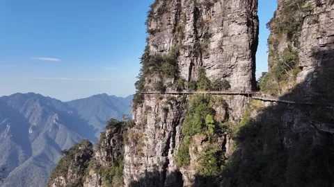 Towering Karst cliffs connected by a narrow cliffside trail in southern China Vídeo Stock 295046422