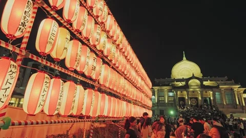 Towering Lantern Wall Beside Fully Lit Temple Facade and Entrance Steps Stock Footage 345841064