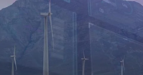 Towering large wind turbine capturing data analytics over mountain valley, with Stock Photos