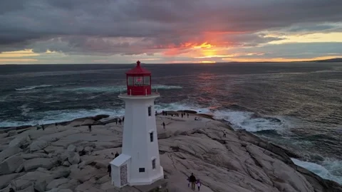 Towering Lighthouse Faces Ocean As Sunset Colors Paint Sky In Nova Scotia Coast Stock Footage 314464679
