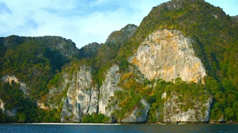 Towering, Limestone Seacliffs over a Tropical Wilderness Beach Stock Footage 54479745