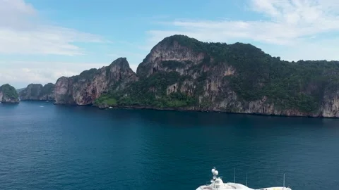 Towering Limestone stalled by shoreline winding around Ko Phi Phi Don Island Stock Footage 229711935