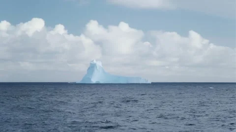 Towering melting iceberg global warming concept. Snow covered glacier float Stock Footage 322546036