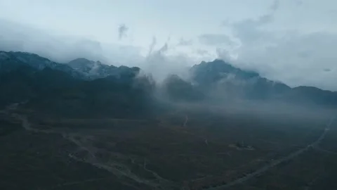 Towering mountains - cloudy - vast land Stock Footage 228675974