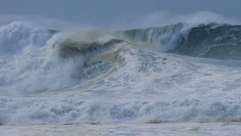 Towering Ocean Wave Breaking with Intense Force in Deep Blue Waters Stock Footage 297511437