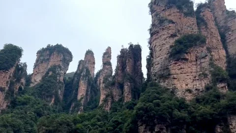 Towering quartz‑sandstone pillars rise dramatically in Yuanjiajie, Stock Footage 342912296