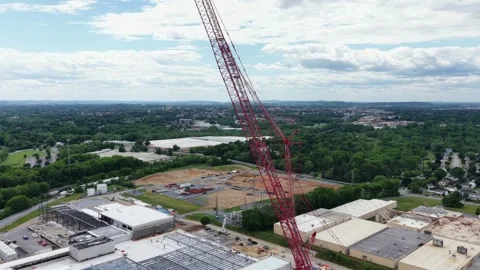 Towering red cranes rise above new data center site in Lancaster, with cleared Stock Footage 337978514