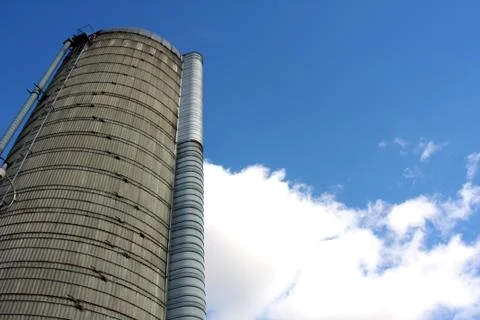 Towering silo and blue sky Stock Photos