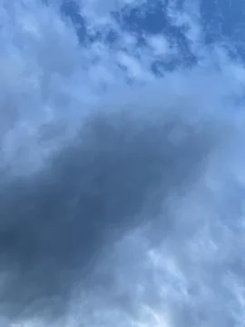 Towering Storm Cloud Against Blue Sky Stock Photos