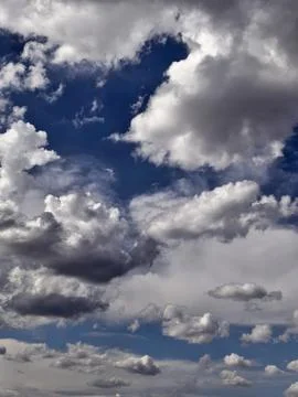 Towering Storm Clouds Against Dramatic Deep Blue Sky Stock Photos