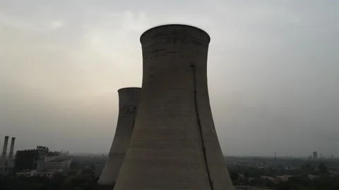 Towering View of Massive Concrete Cooling Chimneys at a Thermal Power Station Stockbeeldmateriaal 332580169