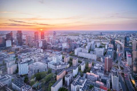 Towering Warsaw skyline at sunset with dramatic sky over Poland skyscrapers Stock Photos