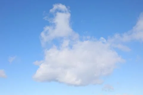 Towering white cloud with vertical development in the clear blue foreign sk.. Stock Photos