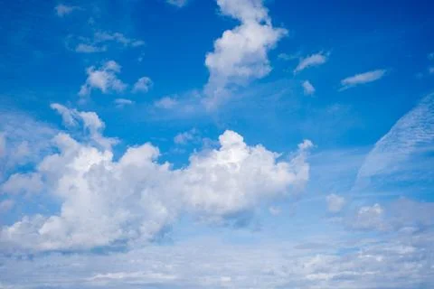 Towering White Clouds Against Clear Blue Sky Stock Photos