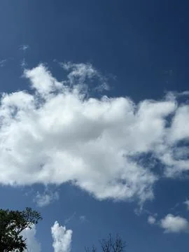 Towering White Cumulus Cloud in Blue Sky Stock Photos