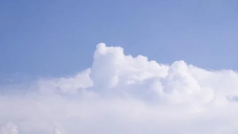 Towering White Cumulus Cloud Floating In Bright Blue Summer Sky Stock Photos