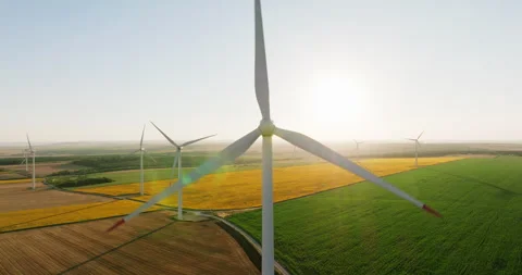 Towering white wind turbines stand against rolling hills, Stock Footage 301892574