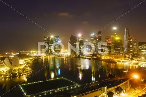 The towers of the Central Business District and Marina Bay by night, Singapore, Stock Photos
