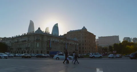 Towers of the Flame Towers complex, against backdrop of shining sun disc in blue Stock Footage 234458631