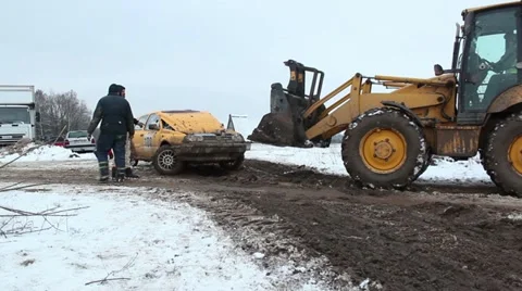Towing broken car on track with tractor in winter, rallycross Stock Footage 10835946