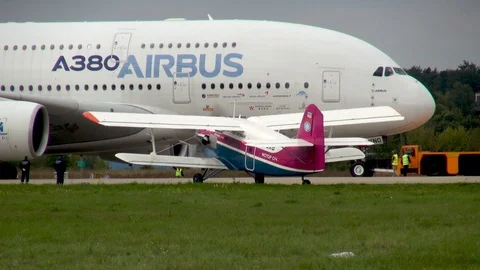 Towing four-engine wide-bodied two-story passenger Airbus A-380 passenger. Stock Footage 118647604