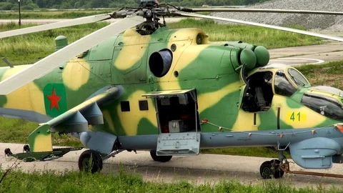 Towing military helicopter Mi-35 or Mi-24 (NATO: Hind) after flights. Stock Footage 123762500