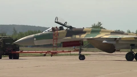 Towing multipurpose fighter Su-35 (NATO - Flanker-E)  to static parking lot. Stock Footage 219809394