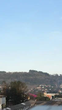 Town Below Forested Hillside 스톡 사진