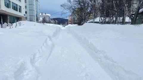 Town buried in deep snow after massive blizard. Cleared road after a snow storm Stock Footage 263007769