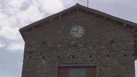 Town hall village facade clouds sky facade building stone clock tower afternoon Stock Footage 332647340