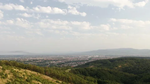 Town from hill. Clouds move above hill. Kraljevo, Serbia Stock Footage 41579865