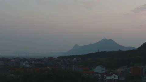The town on the mountain side at night before the sun goes down Stock Footage 145327618