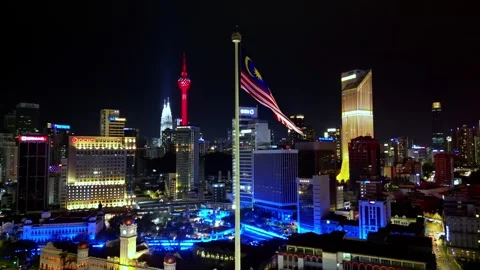 A town at night with a red tower in the 스톡 동영상 318093745