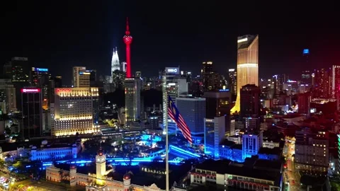 A town at night with a red tower in the 스톡 동영상 318102920