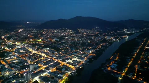 A town at night with a river running through it Видео 318269727