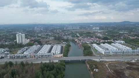 A town with a river running through it. The river is next to a bridge Stock-Footage 318100208