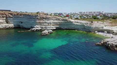 Townscape and small beach with people, rocky Stock Footage 299679852