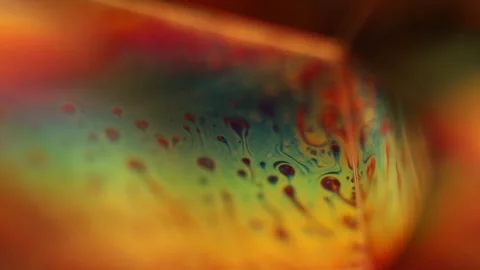 Toxic coloured liquid film reflection, macro video Stock Footage 314235014
