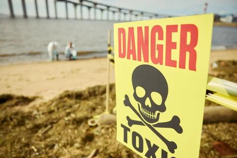 Toxic Danger Warning Sign on Polluted Beach with Scientists Stock Photos